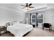 Bright bedroom with tray ceiling, black metal bed frame, and windows offering plenty of natural light at 5751 Green Arbor Way, Sugar Hill, GA 30518