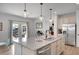Spacious kitchen island featuring granite countertops, dual sinks, pendant lighting, and stainless steel appliances at 5751 Green Arbor Way, Sugar Hill, GA 30518
