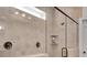 Beautifully tiled shower with glass enclosure, dual shower heads, and recessed shelf at 5751 Green Arbor Way, Sugar Hill, GA 30518