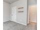 Bedroom view with neutral walls, carpet, a white door, and wood shelves at 1024 Burke St # 56, Lawrenceville, GA 30046
