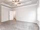 Large bedroom with tray ceiling, fan, carpet and an entrance to a bathroom at 1024 Burke St # 56, Lawrenceville, GA 30046