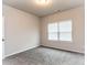 Bedroom showcasing neutral walls, carpeted flooring, and a bright window at 1024 Burke St # 56, Lawrenceville, GA 30046