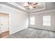 Bright bedroom with tray ceiling, ceiling fan, carpet, and natural light from two windows at 1024 Burke St # 56, Lawrenceville, GA 30046