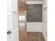 A stylish entryway featuring wood floors, elegant white wainscoting, and decorative wallpaper at 1024 Burke St # 56, Lawrenceville, GA 30046