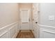 Entryway featuring hardwood floors, white trim, and a door leading to the exterior with built-in blinds at 1024 Burke St # 56, Lawrenceville, GA 30046