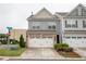 Charming two-story townhome featuring a two-car garage, well-maintained lawn, and lovely landscaping at 1024 Burke St # 56, Lawrenceville, GA 30046