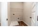 Laundry area with overhead shelving, hookups, and wood look flooring at 1024 Burke St # 56, Lawrenceville, GA 30046