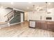 Open living space featuring hardwood floors, stairs, modern wallpaper, and a view into the kitchen at 1024 Burke St # 56, Lawrenceville, GA 30046