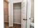 Pantry with an open white door, adjustable shelving, and wood look flooring at 1024 Burke St # 56, Lawrenceville, GA 30046