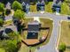 Aerial view of a fenced backyard featuring a trampoline and playhouse, surrounded by lush greenery at 174 Riverwood Dr, Dallas, GA 30157