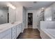 Bathroom features a large vanity, glass shower, soaker tub, and closet at 174 Riverwood Dr, Dallas, GA 30157
