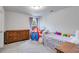 Bright bedroom with a play tent, area rug, and a light fixture creating a playful and inviting atmosphere at 174 Riverwood Dr, Dallas, GA 30157