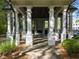 View of a community gazebo with stone fireplace, stone pavers, and pillars at 174 Riverwood Dr, Dallas, GA 30157
