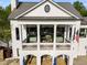 Elegant home featuring a balcony, stone accents, and a well-maintained lawn at 174 Riverwood Dr, Dallas, GA 30157