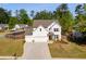 Beautiful home with a three-car garage, well-kept lawn, and a wooded backdrop at 174 Riverwood Dr, Dallas, GA 30157