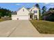 Charming two-story home with a three-car garage and a well-manicured front lawn at 174 Riverwood Dr, Dallas, GA 30157