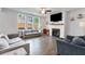 Cozy living room with fireplace, large windows, and comfortable seating for relaxation at 174 Riverwood Dr, Dallas, GA 30157