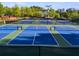 View of the community pickleball courts with blue courts with white trim and black fencing at 174 Riverwood Dr, Dallas, GA 30157