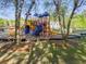 View of the community playground with slide, climbing area, and benches at 174 Riverwood Dr, Dallas, GA 30157