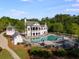 Stunning community pool and clubhouse surrounded by lush greenery, with ample seating and shade for relaxation at 174 Riverwood Dr, Dallas, GA 30157