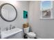 Chic powder room featuring a pedestal sink, decorative mirror, and stylish fixtures at 174 Riverwood Dr, Dallas, GA 30157