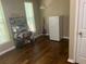 Bright dining area features a window, shelving unit, and a refrigerator, all complementing the hardwood floors at 2253 Dillard Xing, Tucker, GA 30084
