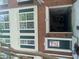 Charming brick and siding townhome with dark green shutters and entry door and bright white trim and garage door at 2253 Dillard Xing, Tucker, GA 30084