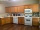 Well-equipped kitchen with wooden cabinets, stainless appliances, and hardwood flooring at 2253 Dillard Xing, Tucker, GA 30084