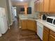Well-lit kitchen with wood cabinets, stainless steel sink, and updated appliances, designed for everyday cooking and entertaining at 2253 Dillard Xing, Tucker, GA 30084