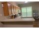 Contemporary kitchen with wooden cabinetry, updated appliances, and a breakfast bar area at 2253 Dillard Xing, Tucker, GA 30084