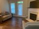 Inviting living room featuring a fireplace, comfortable seating, and hardwood floors at 2253 Dillard Xing, Tucker, GA 30084
