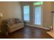 Bright living room with stylish sofa, hardwood floors, and access to natural lighting at 2253 Dillard Xing, Tucker, GA 30084