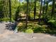 The backyard boasts mature trees with a glimpse of the surrounding neighborhood, as seen from the rooftop at 2704 Terratim Ln, Decatur, GA 30034