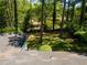 View of the expansive backyard from the house's roof, surrounded by mature trees and lush greenery at 2704 Terratim Ln, Decatur, GA 30034