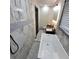 Bright bathroom with marble tile, modern vanity, soaking tub, and neutral decor at 2704 Terratim Ln, Decatur, GA 30034