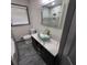 Modern bathroom with a glass vessel sink, sleek black cabinetry, and marble-look tile flooring at 2704 Terratim Ln, Decatur, GA 30034