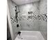 Modern bathroom with marble tiling, rainfall shower head, and luxurious soaking tub at 2704 Terratim Ln, Decatur, GA 30034