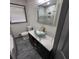 Bright bathroom with gray vanity, marble counter, glass sink, and modern fixtures at 2704 Terratim Ln, Decatur, GA 30034