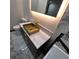 Modern bathroom featuring marble countertops, gold hardware, and an illuminated mirror at 2704 Terratim Ln, Decatur, GA 30034
