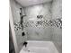 Beautiful bathroom featuring a soaker tub, rain shower, and elegant marble tile throughout at 2704 Terratim Ln, Decatur, GA 30034