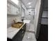 Modern bathroom with golden vanity, soaking tub, marble tile, and rainfall shower at 2704 Terratim Ln, Decatur, GA 30034