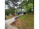 View of a single-story home, with a newly poured long driveway and a front yard situated on a slightly sloped lot at 2704 Terratim Ln, Decatur, GA 30034