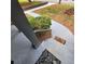 Inviting front porch and doorway with gray steps, black hand railing, and green landscaping at 2704 Terratim Ln, Decatur, GA 30034