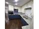 Bright kitchen with stainless steel appliances, granite countertops, and stylish blue cabinets at 2704 Terratim Ln, Decatur, GA 30034