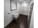 Laundry room showcasing modern fixtures, window, sink, hardwood floors and convenient built in shelves at 2704 Terratim Ln, Decatur, GA 30034