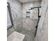 Modern shower with marble tile, herringbone accent, niche, and rainfall shower head at 2704 Terratim Ln, Decatur, GA 30034