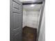 Spacious walk-in closet featuring wood flooring and open shelving for optimal storage and organization at 2704 Terratim Ln, Decatur, GA 30034