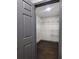 Spacious walk-in closet featuring installed shelving and dark wood floors at 2704 Terratim Ln, Decatur, GA 30034