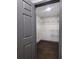 Spacious walk-in closet featuring wood flooring and open shelving for optimal storage and organization at 2704 Terratim Ln, Decatur, GA 30034