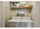 Convenient laundry room with a washer and dryer, as well as shelving for storing supplies at 3040 Peachtree Nw Rd # 713, Atlanta, GA 30305